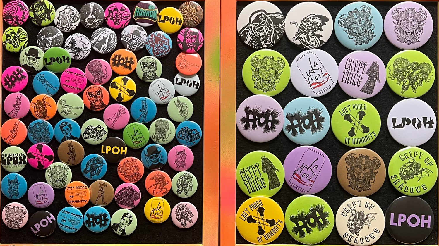 Two boxes of handmade buttons with various designs and text, displayed on a textured surface.